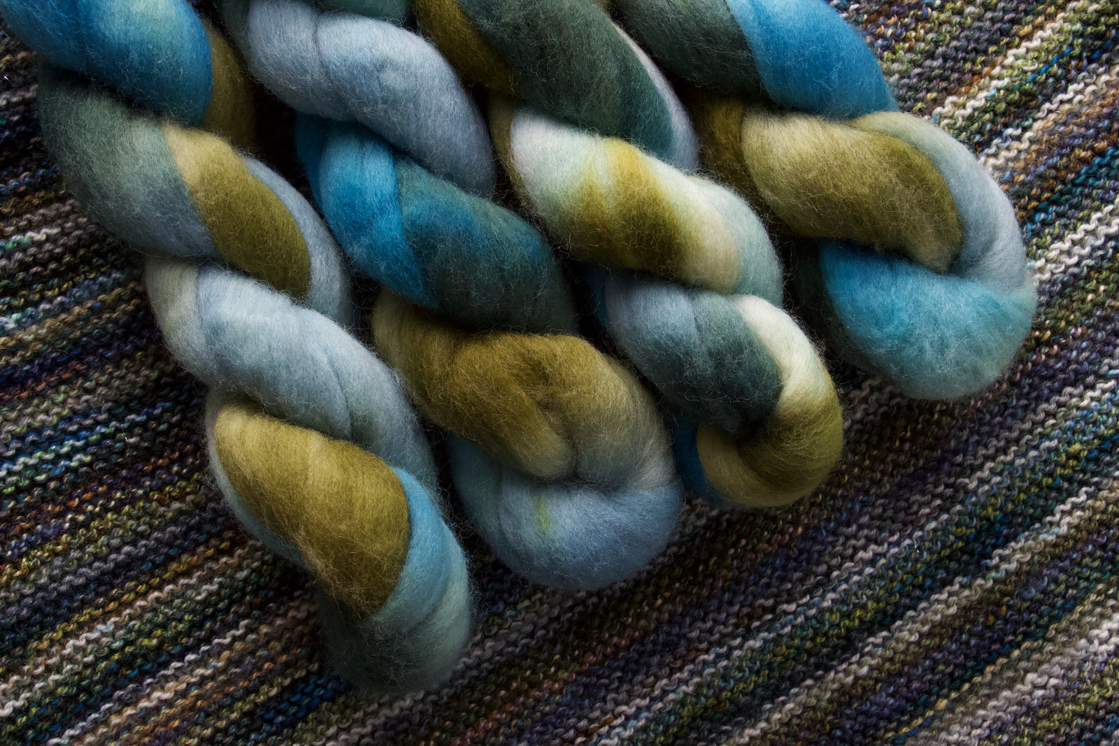 Multicolored fiber skein on a knitted fabric background