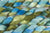 Braided fiber skein with green and blue gradient on a white background