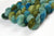 Braided fiber skein with green and blue gradient on a white background