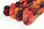 Braided fiber skein with red, orange, gold, and purple on a white background