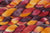 Braided fiber skein with red, orange, gold, and purple on a white background