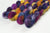 Braided fiber skein with blue, purple, pink, and gold on a white background