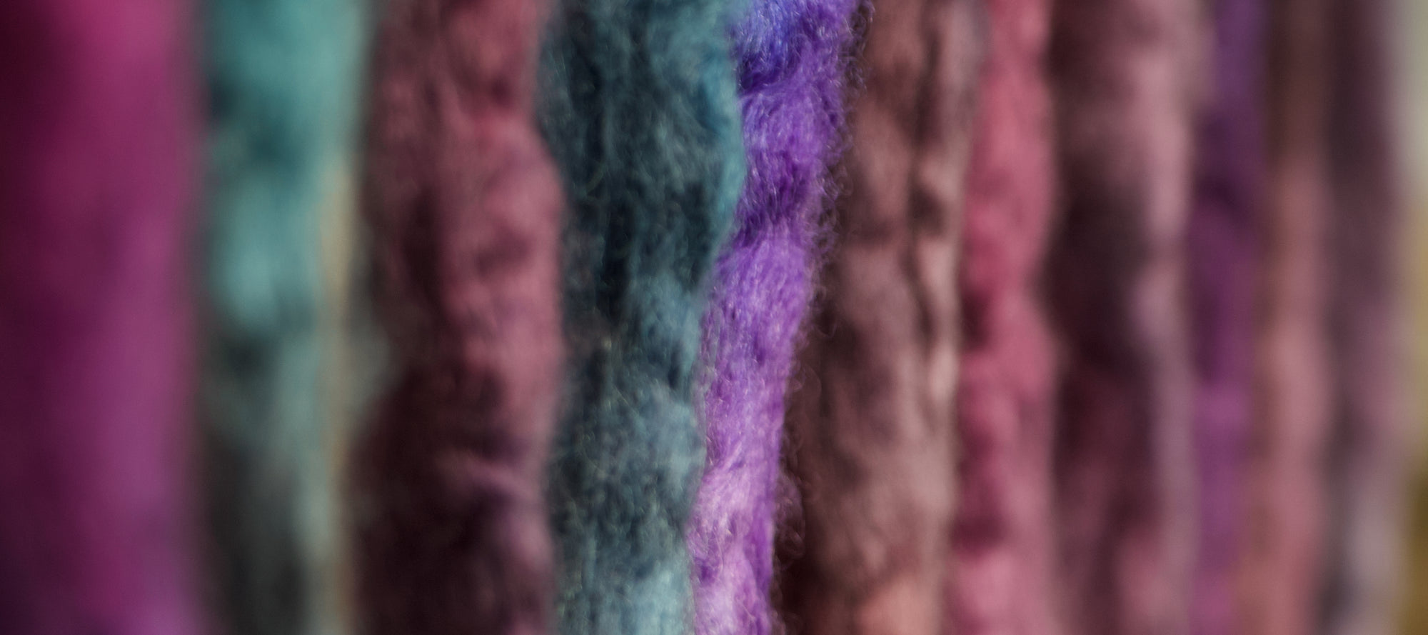 Close-up of colorful spinning fibers in a row